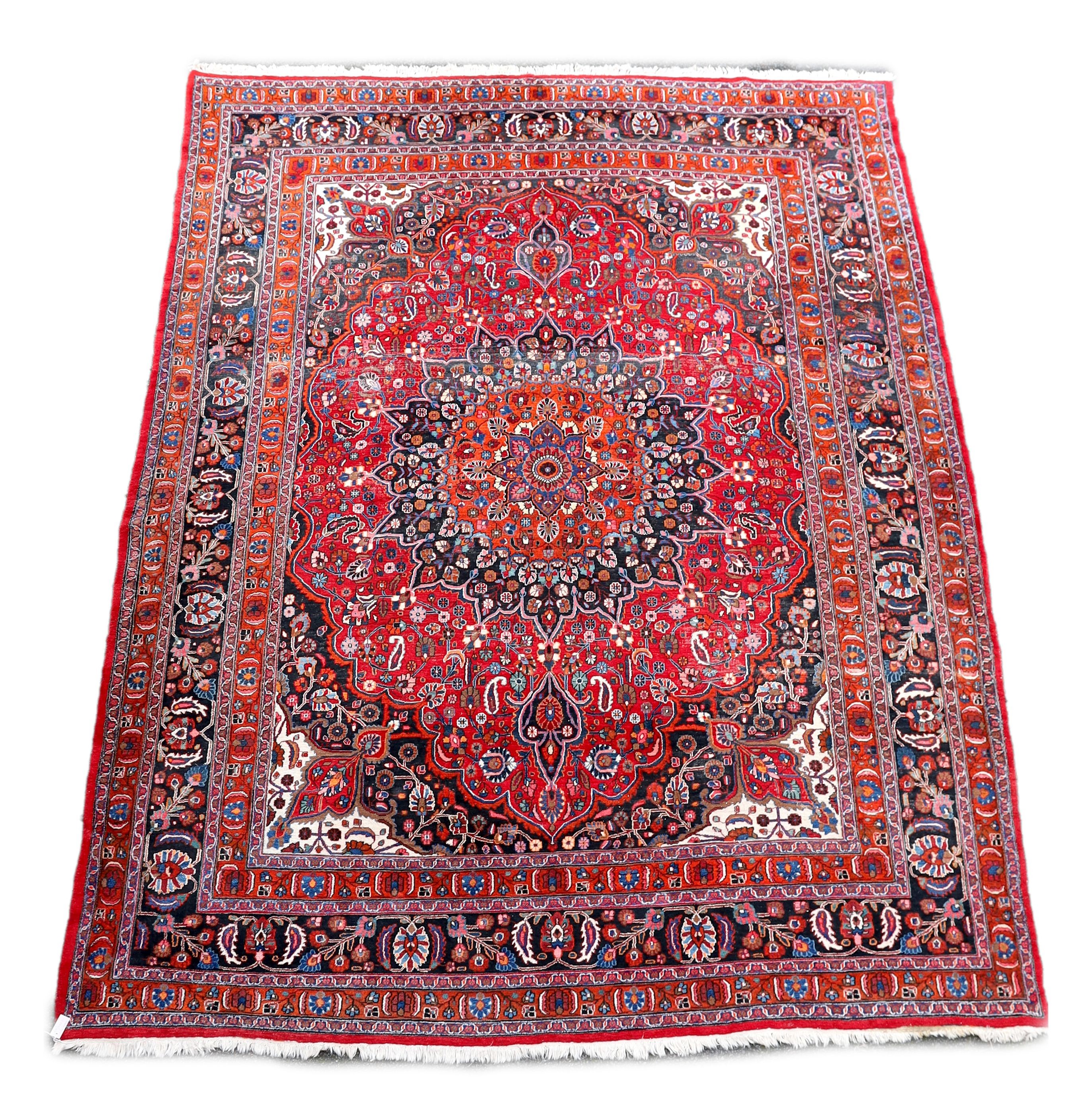 A Tabriz red ground carpet 422 x 326cm.